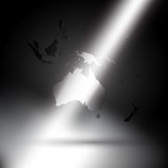 Australia map in rays of light on gray background