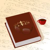 book with gold ornament cup of coffee