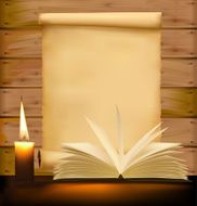 Old paper candle and open book on wood background