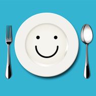 Smile face draw on white plate with spoon and fork