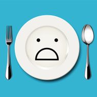 Horror face draw on white plate with spoon and fork