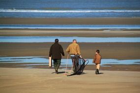 people with fishing gear on the coast