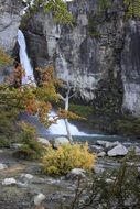 waterfall on the background of the picturesque landscape