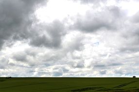 grey clouds over the farm field