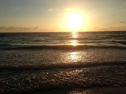 sunset on the horizon of a wavy sea
