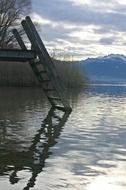 wooden staircase on the pier for the descent into the lake