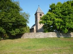 stone church among green trees