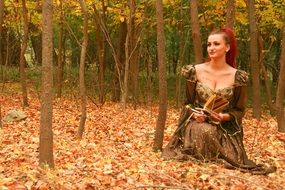 girl sitting on yellow leaves