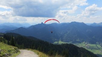 skydiver flies over the mountain