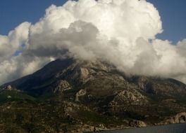 thick white clouds over the top of the mountain in Greece