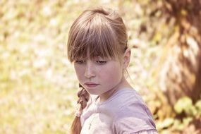 girl near the trees looking down