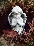 figurine of a praying angel kneeling