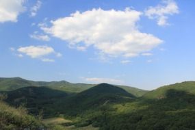 clouds over green mountains