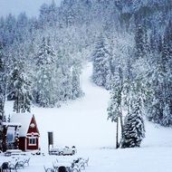 house at the foot of the mountain in winter