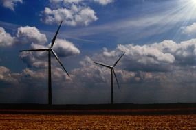 wind turbines against cloudy sky