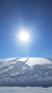 bright sun over the mountain in the snow