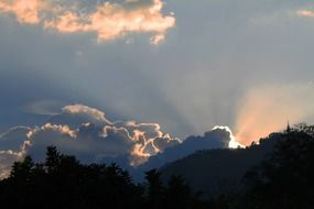 picturesque landscape of clouds and sun at sunset