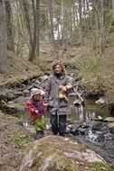 mother with daughter in the autumn forest