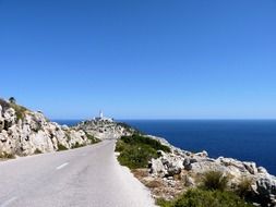 road through a mountain pass near the blue sea