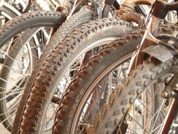 brown rusty wheels of bikes