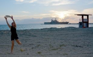 girl with frisbee on the beach