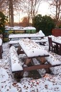 picnic tables in snow