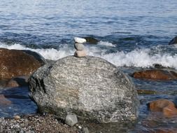pile of stones on a boulder by the sea