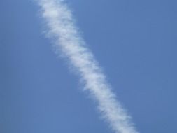 airplane trail in the blue sky