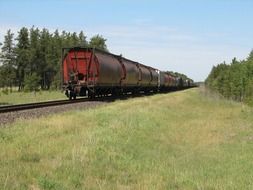 perspective of freight train on railway at summer