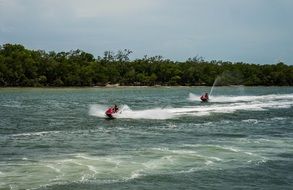 water sports on the waves from jet skis near the shore in Florida