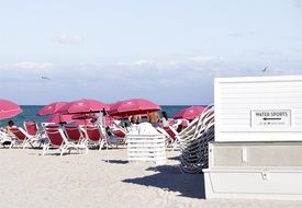 sun umbrellas and deck chair on the beach in florida