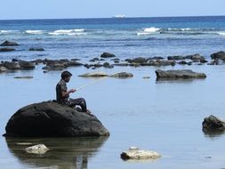 fisherman on a big stone in Litoral