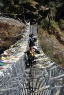 crossing the mountain bridge in Nepal