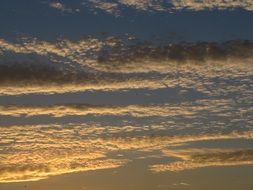 golden stripes of clouds at evening sky