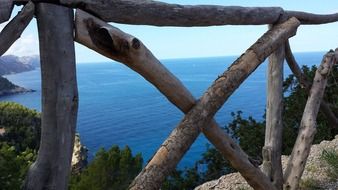 view of the sea through the wooden fence