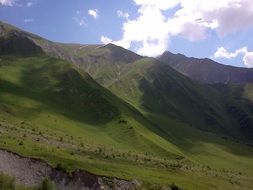 scenic green caucasus mountains beneath blue sky, south ossetia