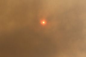 sun behind smoke from bushfire