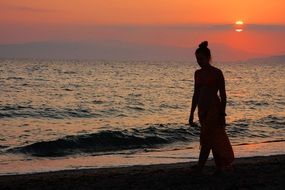 girl by the ocean at sunset