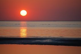 landscape of bright sun and red sunset over the sea