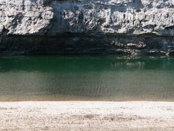 calm water in the river near the rock