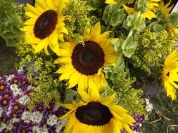 a huge bouquet of flowers such as sunflowers and daisies