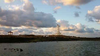 white lighthouse on Jeju island by the sea