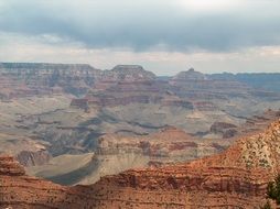 grand canyon, scenic red mountains beneath grey clouds, usa, utah