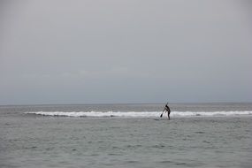 standup paddleboarding on the small waves