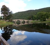 stone bridge over quiet river in scotland