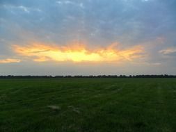 romantic sunset over arable field