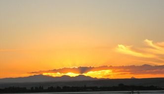distant view of a yellow sunset in the clouds