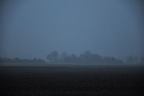 Autumn landscape with fog at dusk