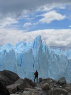 man stands on top of a glacier
