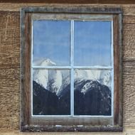 reflection of mountains in a closed window